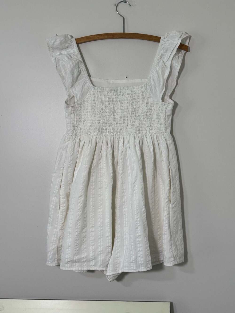 American Eagle cream romper with a tassel tie